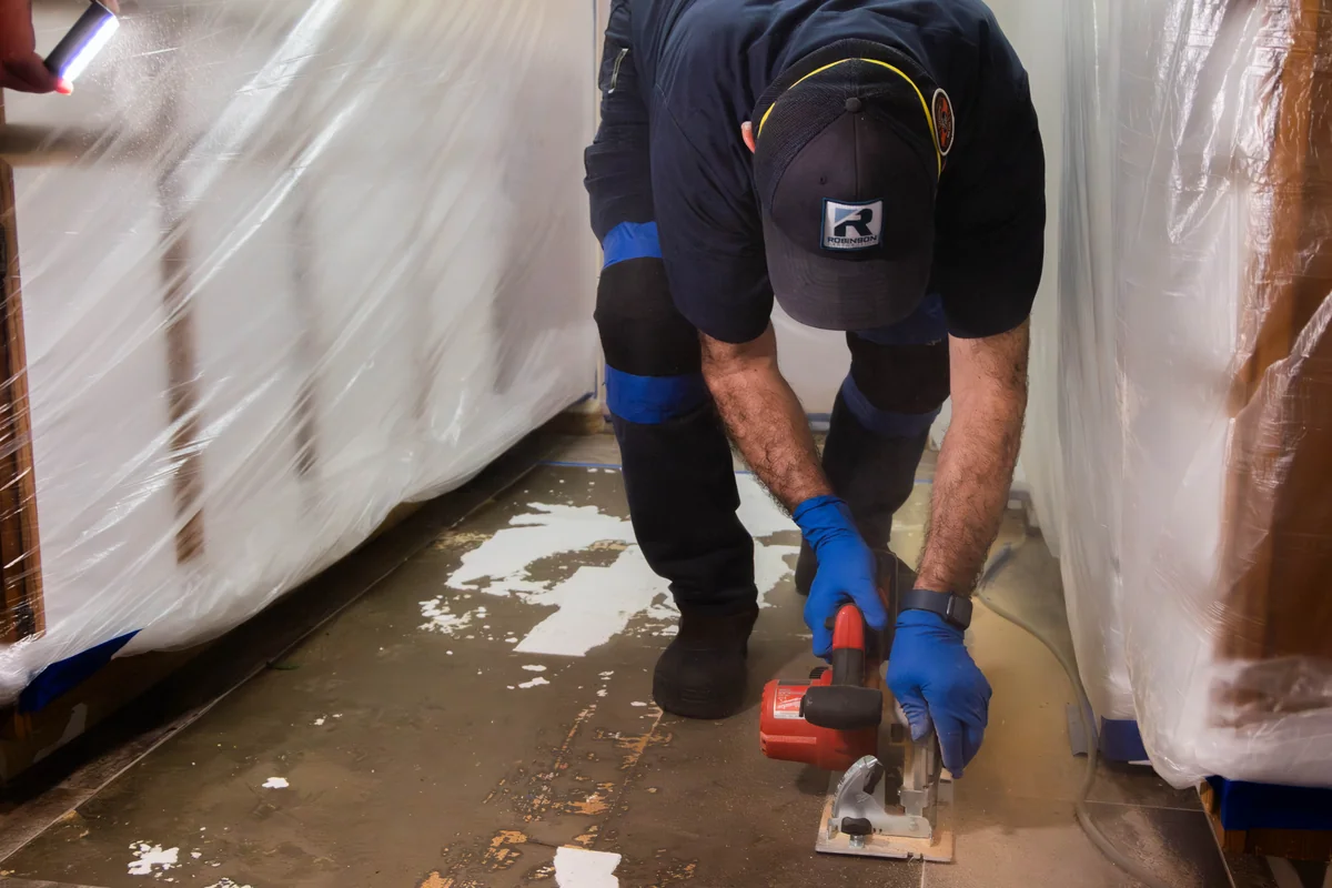 Robinson Restoration technician setting drying equipment on a water loss
